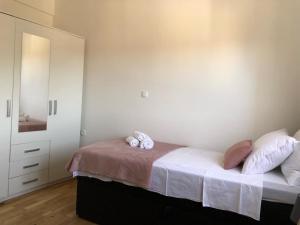 a bedroom with a bed with two pillows on it at Apartman FILIPA in Jezera