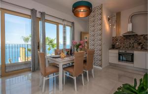 a kitchen and dining room with a table and chairs at Amazing Home In Baska Voda With House Sea View in Baška Voda