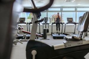 a woman standing on a treadmill in a gym at Nissi Beach Resort in Ayia Napa