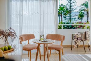 a table and chairs in a room with a window at Nissi Beach Resort in Ayia Napa