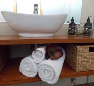 a shelf with towels and a sink in a bathroom at Port McCrae in McCrae
