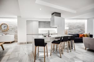 a kitchen with a table and chairs in a room at HO By Olivencia Paseo de Almeria 45 in Almería +19 photos
