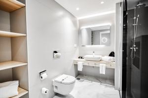 a bathroom with a toilet and a sink at HO By Olivencia Paseo de Almeria 45 in Almería