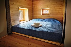 a bedroom with a bed in a wooden cabin at La Marmote Albergo Diffuso di Paluzza Faas in Paluzza