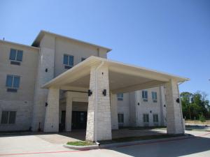 a large building with a large open garage at Best Western Plus Chandler in Chandler
