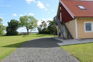 a building with a staircase next to a grass field at Kärraton Vandrarhem in Åhus