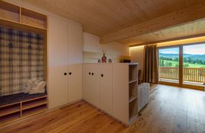 a room with white cabinets and a large window at Pircherhof - Adults Only am Bauernhof in Pöllau