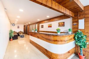 a bar in a lobby with wooden walls at Octave Nest Inn in Bangalore