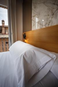 Postel nebo postele na pokoji v ubytování Hotel Dauro Premier