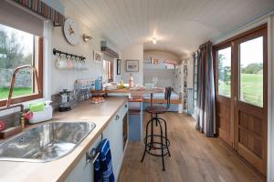a kitchen with a sink and a counter top at Cow Parsley Shepherd's Hut in Berwick-Upon-Tweed