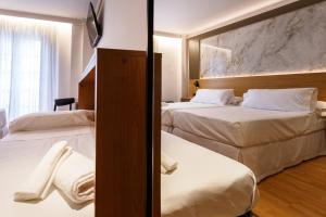 Postel nebo postele na pokoji v ubytování Hotel Dauro Premier