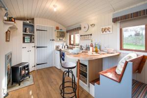 a kitchen with a island in a tiny house at Cow Parsley Shepherd's Hut in Berwick-Upon-Tweed