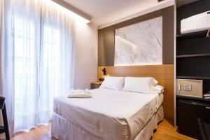 Postel nebo postele na pokoji v ubytování Hotel Dauro Premier