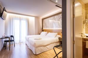 Postel nebo postele na pokoji v ubytování Hotel Dauro Premier