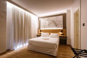 Postel nebo postele na pokoji v ubytování Hotel Dauro Premier