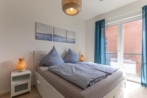 Ένα ή περισσότερα κρεβάτια σε δωμάτιο στο Wohnen am Südstrand - Ferienwohnung 1 4