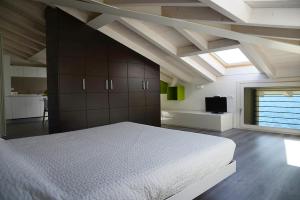 a bedroom with a large white bed and a window at Iseo Lake in Castro