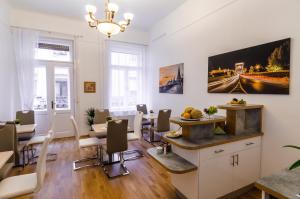 a dining room with a table and chairs in it at Anabelle Bed and Breakfast in Budapest