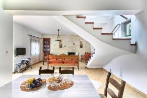 a kitchen and living room with a table with fruit on it at Villa Elia by PosarelliVillas in Vryses