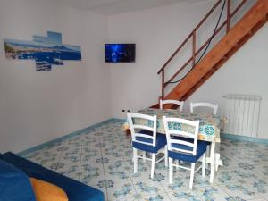 a dining room with a table and chairs at Little House Forio in Forio d'Ischia