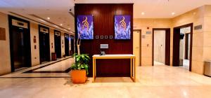a lobby with a table in the middle of a building at Al Ebaa Hotel in Mecca