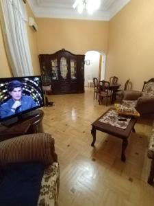 a living room with a couch and a tv at Квартира у моря в Абхазии Сухум in Sukhum