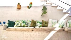 a couch with many pillows on a wall at Paradise Sea Terrace in Monopoli
