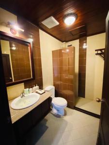 a bathroom with a sink and a toilet and a shower at Luang Prabang Maison Vongprachan & Travel in Luang Prabang +48 photos