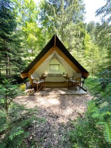 a large tent in the middle of a forest at Glamping Tent Water Village Rogla in Oplotnica