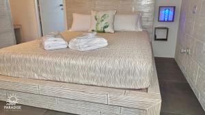 a large bed with towels on top of it at Paradise Sea Terrace in Monopoli