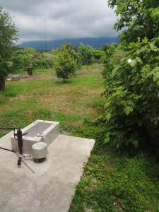 a white sink sitting on top of a field at U Vili in Pizunda