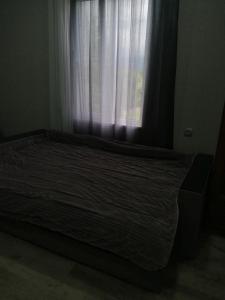 a bed in a room with a window at U Vili in Pizunda