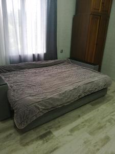 a large bed in a bedroom with a window at U Vili in Pizunda
