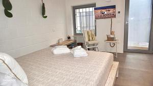 a bedroom with a bed with towels on it at Paradise Sea Terrace in Monopoli