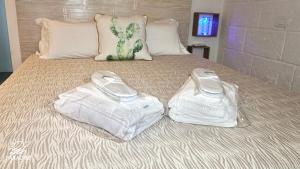 two plastic bags sitting on top of a bed at Paradise Sea Terrace in Monopoli