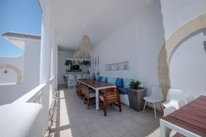 a living room with a table and chairs at Dar Benti in Monastir