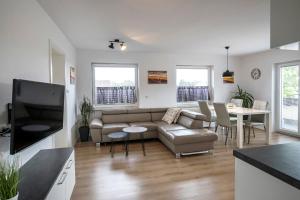 a living room with a couch and a table at Apartments Vila Apolonia in Ljubljana