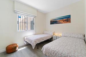 Postel nebo postele na pokoji v ubytování VILLA-CAPRICHO DUNAS DE LA MATA 3