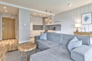 a living room with a couch and a kitchen at Yacht Park Marina by AmberBlue in Gdynia