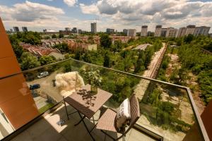 a dog sitting on a balcony with a view of a city at COLORFUL FUSION - Modern Apt at Romexpo in Bucharest