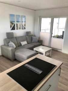 a living room with a couch and a table at Zur Strandwiese W5 in Dahme