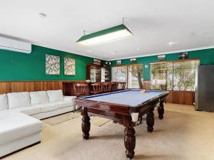 a living room with a pool table in it at Aqua La Vista Mandurah in Mandurah