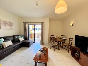 a living room with a couch and a table at Algarve Manta Rota Beach by Homing in Manta Rota