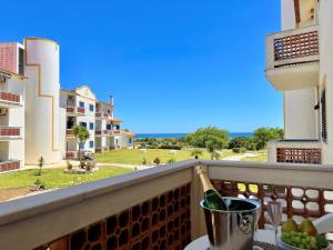 a view from a balcony with a bottle of champagne at Algarve Manta Rota Beach by Homing in Manta Rota