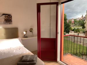 a bedroom with a bed and a sliding glass door at APARTAMENTOS SANTULLANO 2 in Oviedo +13 photos