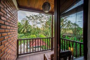 Zimmer mit Balkon und Blick auf den Dschungel in der Unterkunft The Radian Villa Ubud in Ubud