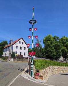a street sign on a pole in front of a house at Pension Wernesgrün in Wernesgrün