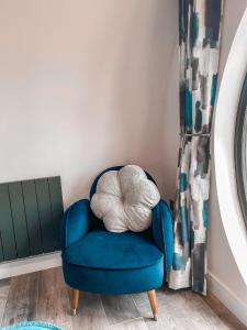 a blue chair with a large pillow in a room at Derecroft Glamping Luxury Lodgepods in Lanchester