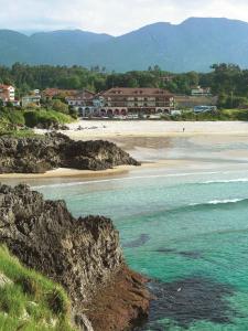 a view of a beach with buildings and the ocean at Hotel Kaype - Quintamar in Barro de Llanes