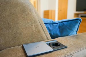 a laptop computer sitting on top of a couch at Nadland Apartments B7 in Vienna